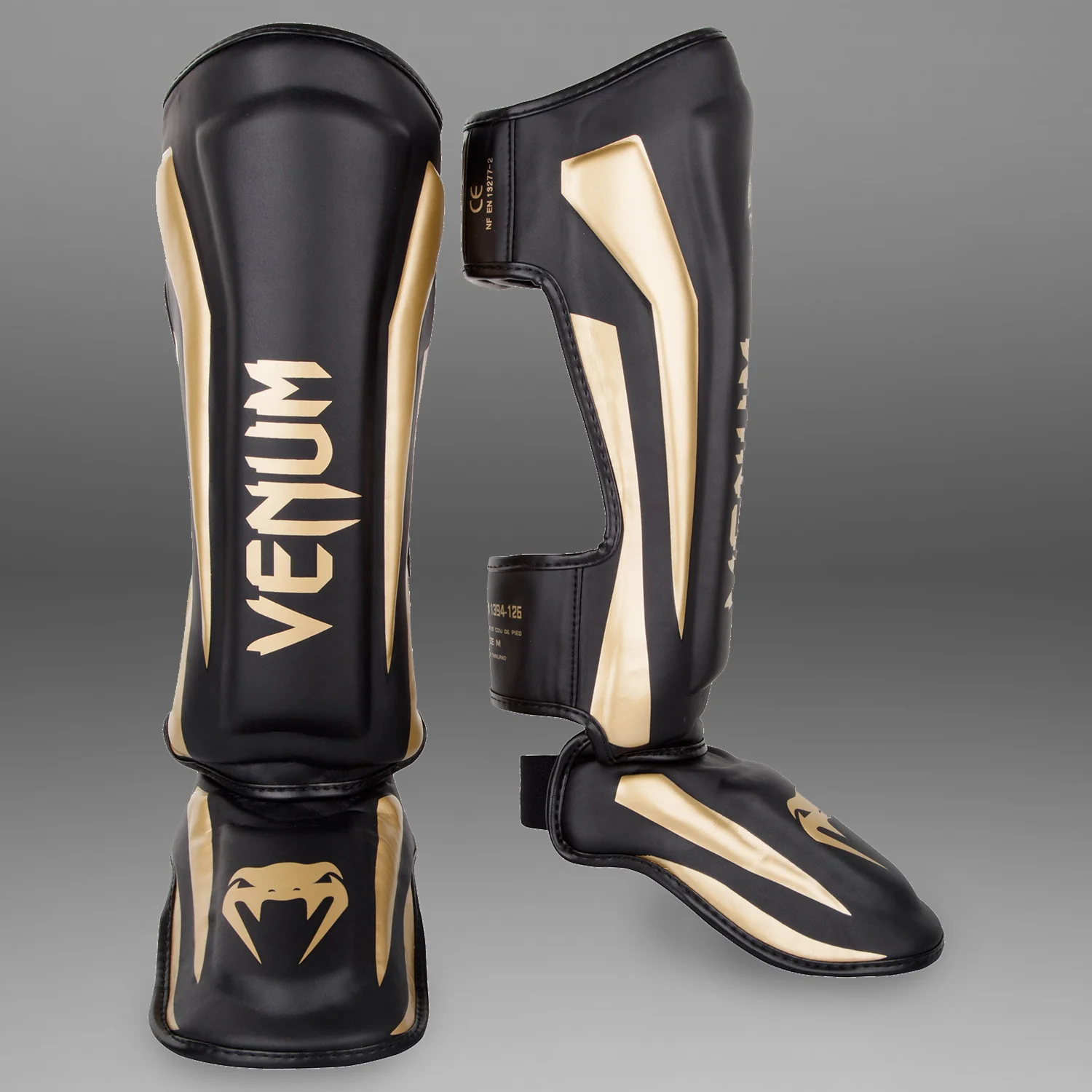 Espinilleras Venum Elite Standup - Negro/Oro